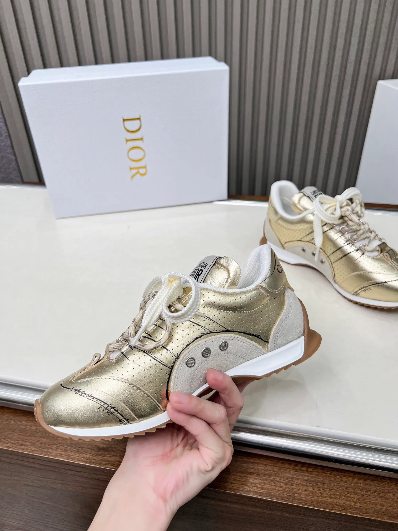 👟👟Ex-factory price 560👟👟 This D-Sketch sneaker is a new product of the 2025 spring and summer ready-to-wear series, highlighting the classic retro aesthetics. Crafted from gold-tone crinkled sheepskin and gold-toned laminated calfskin, it features a printed logo inspired by the shoe's production stages, as well as beige suede calfskin panels and double laces. Hand-written Christian Dior Paris signature on the side, Christian Dior Paris signature panels and plaques on the heel and tongue. Paired with two-tone slim rubber soles, they add a touch of couture to any casual look. Code number: 35~45 Color: black white gold silver